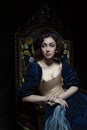 Beautiful girl wearing a medieval dress. Studio works inspired by Caravaggio. Cris. XVII