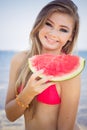 Beautiful girl is wearing red swimsuit eating Royalty Free Stock Photo