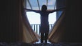 Beautiful girl waking up from the bed is wearing white towel opens curtains and go to sea view terrace. Young woman Royalty Free Stock Photo