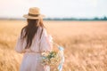 Beautiful girl in wheat field with ripe wheat in hands