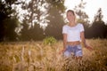 A beautiful girl in a wheatfield on sunset