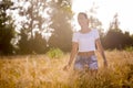 A beautiful girl in a wheatfield on sunset
