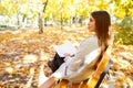 Beautiful girl in a white coat on a background of autumn park. Royalty Free Stock Photo