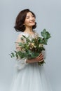 Beautiful girl in white dress with big bouquet Royalty Free Stock Photo