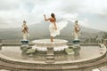 Beautiful Girl In White Dress Fluttering In Wind Looking At Agung Volcano In Bali, Indonesia. Royalty Free Stock Photo