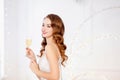 Beautiful girl in white dress and glass of champagne in hands New Year or Christmas party, silver color Royalty Free Stock Photo