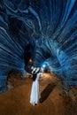 Beautiful girl in white dress walking in blue cave, Thailand