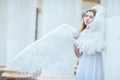 Beautiful girl in a white dress with wings Royalty Free Stock Photo