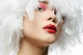 Beautiful Girl in white feathers. young woman Royalty Free Stock Photo