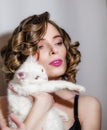 Beautiful girl with a white fluffy cat in her arms. Royalty Free Stock Photo