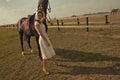 Beautiful girl in a white gown with horse Royalty Free Stock Photo