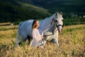 Beautiful girl with white horse in field Royalty Free Stock Photo