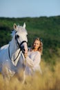 Beautiful girl with white horse in field Royalty Free Stock Photo