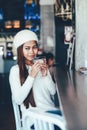 Beautiful girl in white outfit drinking Martini in a bar Royalty Free Stock Photo