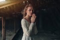 Beautiful girl in in white vintage dress with curly hair posing on the attic. Woman in retro dress. Worried sensual emotion . Retr Royalty Free Stock Photo