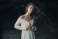 Beautiful girl in in white vintage dress with curly hair posing on the attic. Woman in retro dress. Worried sensual emotion . Retr Royalty Free Stock Photo