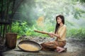 Beautiful girl winnowing rice separate between rice and rice husk