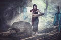 Beautiful girl winnowing rice separate between rice and rice husk