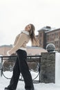 Beautiful girl in winter clothes on a background of the city