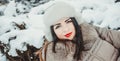 Beautiful girl in winter park, fir-trees covered with frost and snow Royalty Free Stock Photo