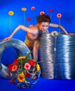 Beautiful girl with wire rolls and flowers Royalty Free Stock Photo