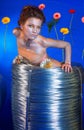 Beautiful girl with wire rolls and flowers Royalty Free Stock Photo