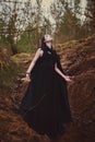 Beautiful girl witch conjures in the woods. Royalty Free Stock Photo