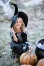 Beautiful girl witch. little girl in which costume celebrate Halloween outdoor and have fun. Kids trick or treating