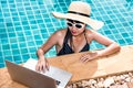 Beautiful girl woman in bikini relaxing pool and using laptop on Royalty Free Stock Photo