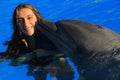 Beautiful girl woman kissing a gorgeous dolphin flipper smiling face happy kid swim bottle nose dolphins Royalty Free Stock Photo