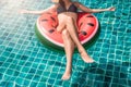 Beautiful girl Woman relaxing on watermelon lilo in pool Royalty Free Stock Photo
