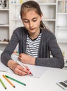 Beautiful girl working on her school project at home. Royalty Free Stock Photo