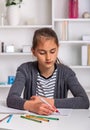 Beautiful girl working on her school project at home. Royalty Free Stock Photo