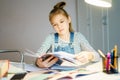 Beautiful girl working on her school project at home, education concept Royalty Free Stock Photo