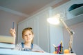 Beautiful girl working on her school project at home, education concept Royalty Free Stock Photo