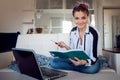 Smiling woman hold her planner. Beautiful girl working at home with laptop. freelance blogger or student