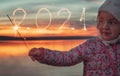 2021 new year. Beautiful girl written with Sparkle firework on sunset background Royalty Free Stock Photo