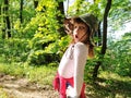 Beautiful girl 6 years old in a hunting hat makes a grimace on her face. Emotion of surprise, fear, or discouragement. Royalty Free Stock Photo