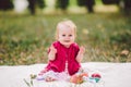 Beautiful Girl 1 Years Old Sitting On The Plaid In The Park. Child outdoor. Baby at picnic in forest. Portrait of a beautiful baby Royalty Free Stock Photo