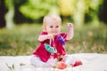 Beautiful Girl 1 Years Old Sitting On The Plaid In The Park. Child outdoor. Baby at picnic in forest. Portrait of a beautiful baby Royalty Free Stock Photo