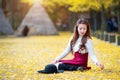 Beautiful Girl with Yellow Leaves in Nami Island. Royalty Free Stock Photo