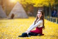 Beautiful Girl with Yellow Leaves in Nami Island. Royalty Free Stock Photo