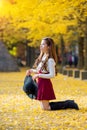 Beautiful Girl with Yellow Leaves in Nami Island. Royalty Free Stock Photo