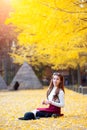 Beautiful Girl with Yellow Leaves in Nami Island, Korea. Royalty Free Stock Photo
