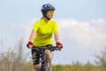 Beautiful girl in yellow riding a bike in nature. Sports and recreation. Hobbies and health