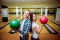 Beautiful girl and young man at the bowling alley Royalty Free Stock Photo