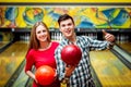 Beautiful girl and young man at the bowling alley Royalty Free Stock Photo