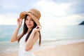 Beautiful girl young woman asia in a  hat smiling on the beach at sunset,enjoy summer vacation on the beach Royalty Free Stock Photo