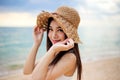 Beautiful girl young woman asia in a  hat smiling on the beach at sunset,enjoy summer vacation on the beach Royalty Free Stock Photo