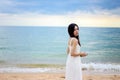 Beautiful girl young woman asia standing in water on sandy on the beach at sunset feeling sad Royalty Free Stock Photo